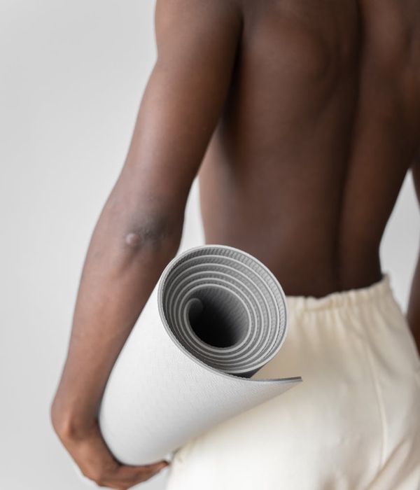 Man performing a core strength exercise on a yoga mat.